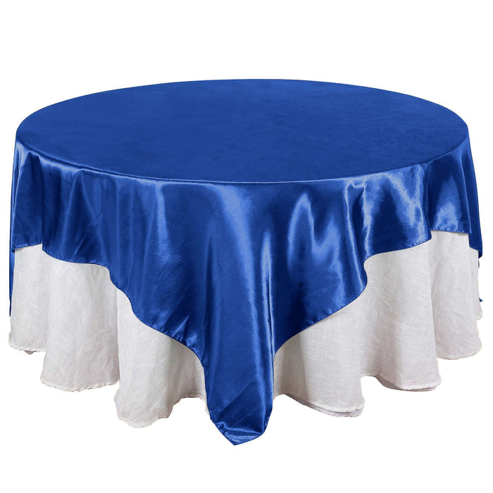 Round blue tablecloth with white skirt, perfect for events and dining.