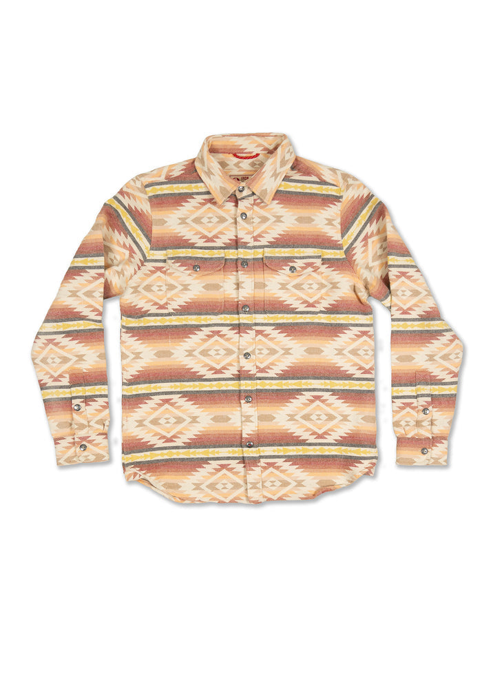 Patterned button-up shirt with geometric designs in earthy tones, featuring a collar and chest pockets on a white background.
