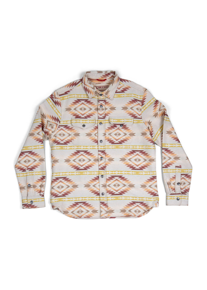 Patterned long-sleeve shirt with geometric designs in earthy tones, featuring a button-up front and two chest pockets.