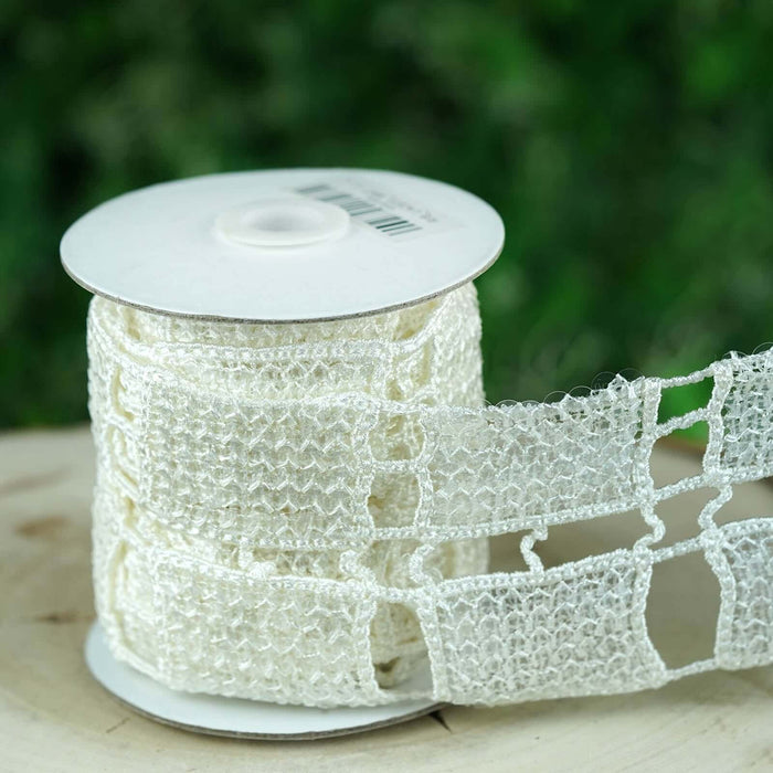 White lace ribbon spool on a wooden surface.