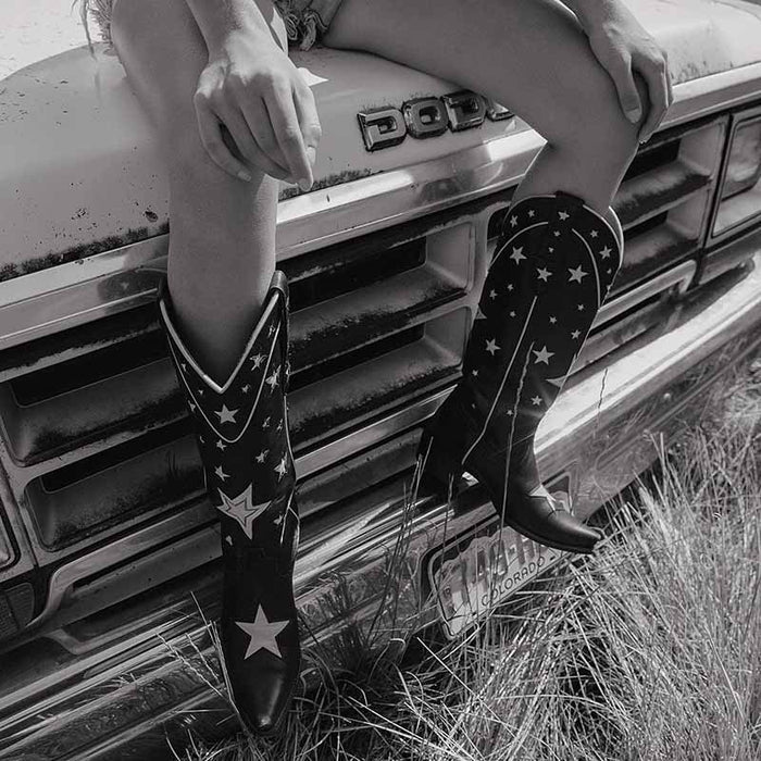 Stylish star embroidered cowboy boots paired with denim shorts, perfect for a chic country look