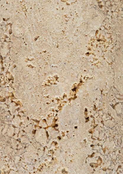 A pair of natural travertine bookends with wavy squiggle shape.